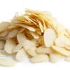 Pile of peeled flaked almonds isolated on white.